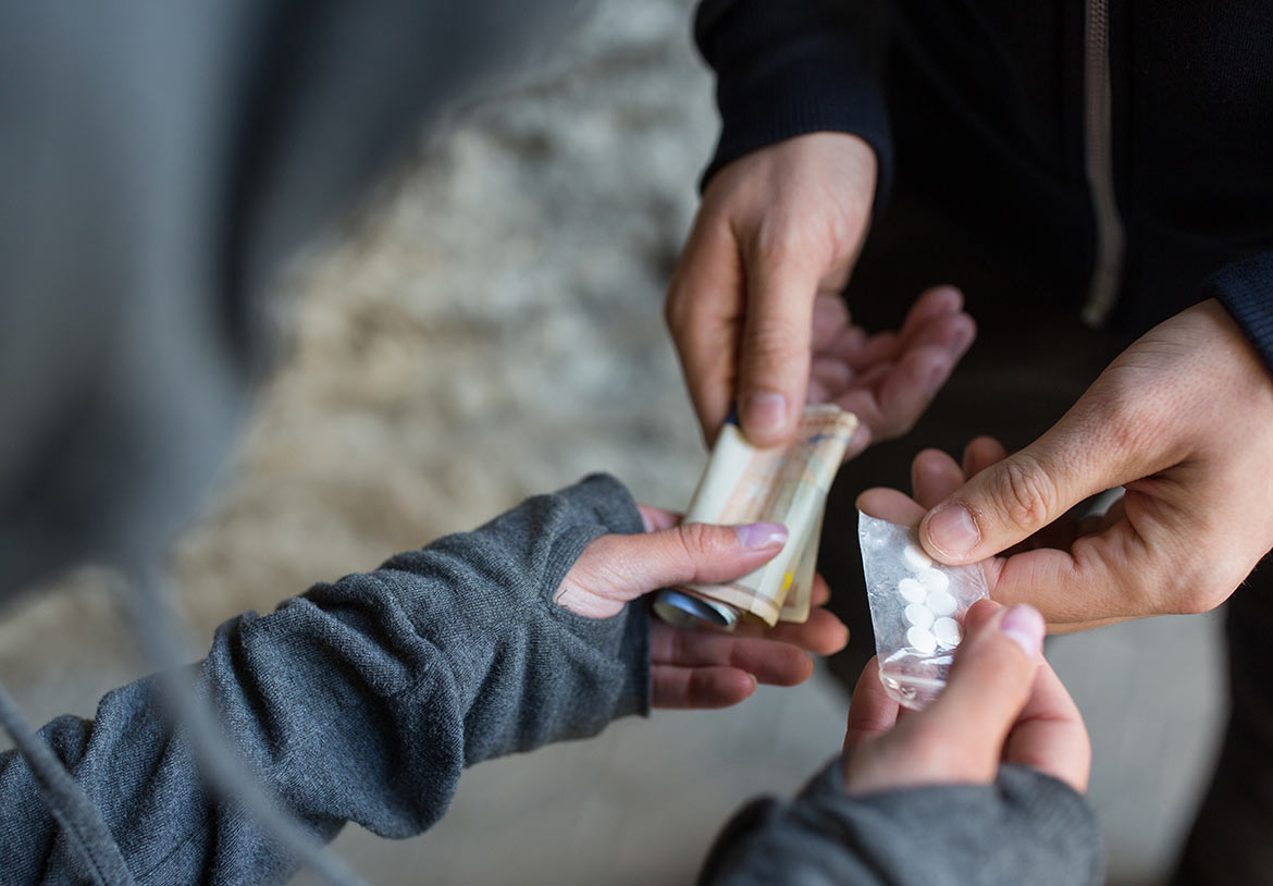 Drug dealer exchanging pills for cash