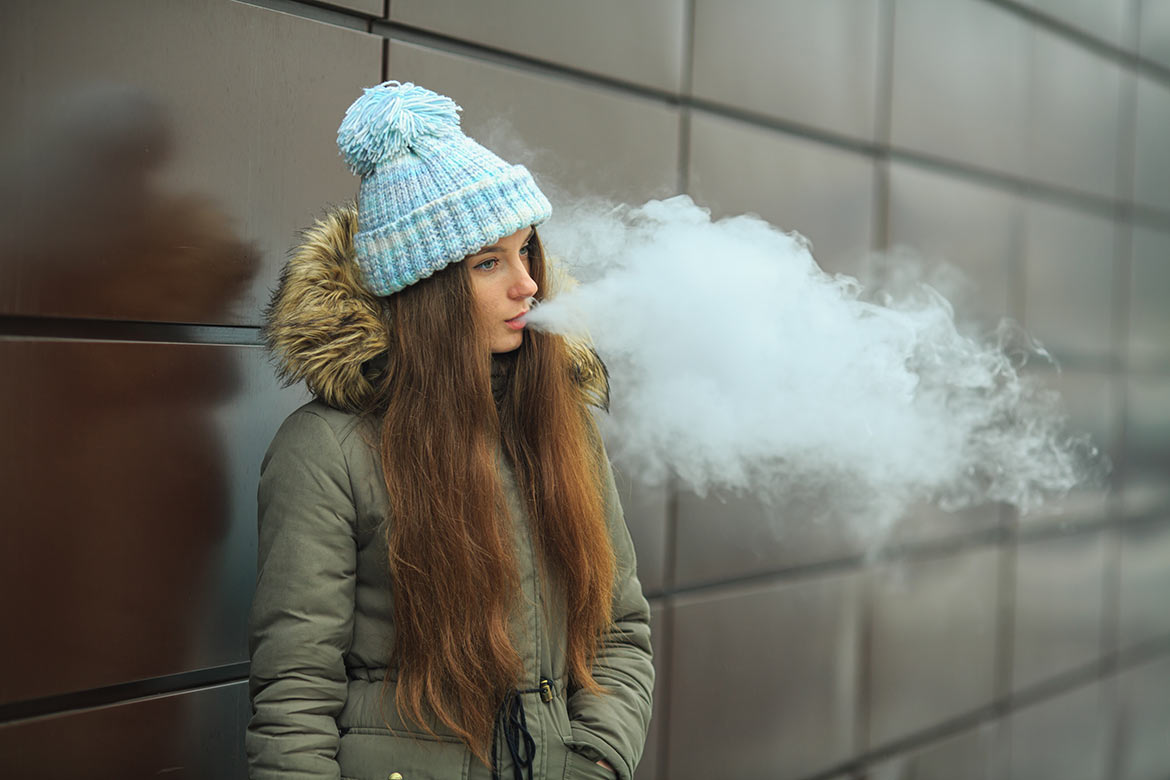 Teenager vaping outside